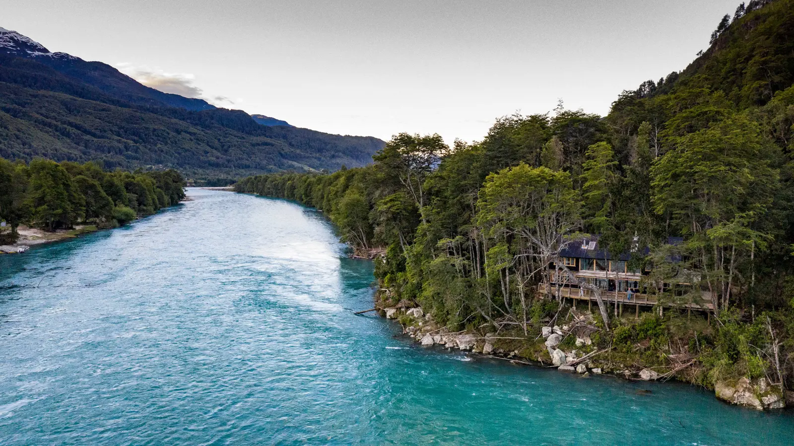 The turquoise Puelo River winding through the forest, seen from the air